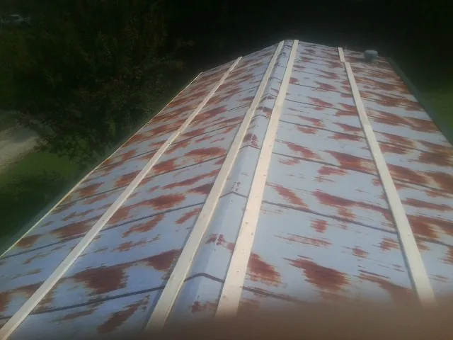 Rusted metal roof panels with new wood purlins before replacement — Storm Damage Roof Repair in Italy by Roofing Brothers